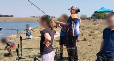 CMR CYCC children try their hand at fishing at Ons Pan during a Bass Hub competition. Title: CMR CYCC children enjoy fishing day