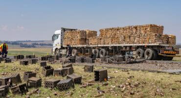 A truck passes on the shoulder as beer bottles, broken glass and crates lie scattered across the Ermelo-Morgenzon road.