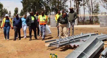Msukaligwa Executive Mayor Mapulane Precious Nkosi examines materials at the Everest Park water project site.