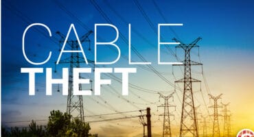High-mast electricity infrastructure with a cable theft warning illustration.