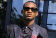 Ermelo model and presenter Siphamandla Nkosi wearing a black formal suit and sunglasses.