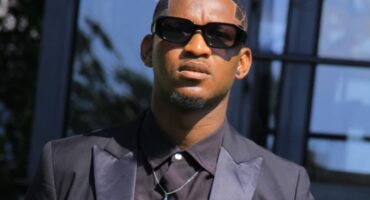 Ermelo model and presenter Siphamandla Nkosi wearing a black formal suit and sunglasses.