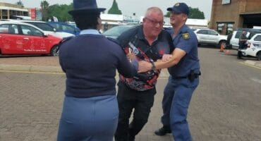 A man attempts to escape as two police officers apprehend him during a previous SANBS Jail and Bail Blood Drive in Ermelo.
