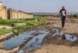 Owethu Rubeka stands in Sulima Street, where sewage collects near her family’s home and preschool.