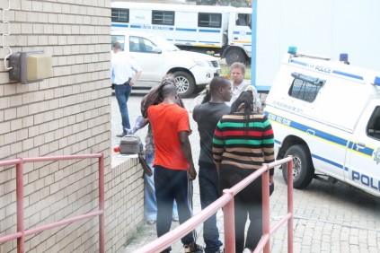 The three accused are lead away by the police.