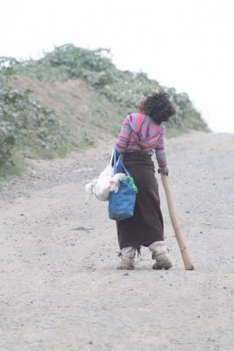 One of the squatters at Secunda dumping site leave with her few belongings.