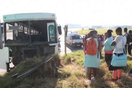 Passengers of the bus wait for alternative transport.