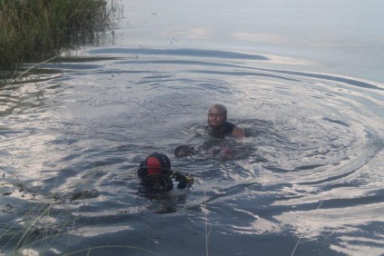 The divers have found the body of one of the men.