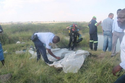 The covered bodies of the three Mozambicans.