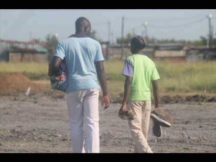 Friends carry the clothes of the deceased.