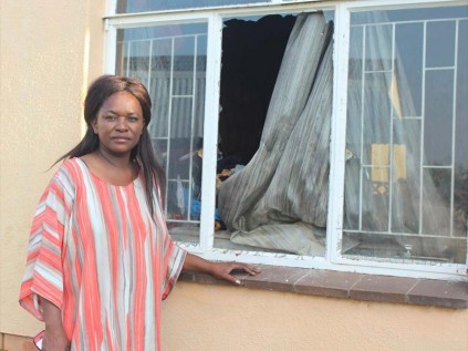 Ms Rachael Mabetlela at the window through which her disabled son was rescued.