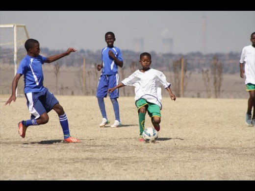 Players of Secunda Celtics and Thistle Grove in action.