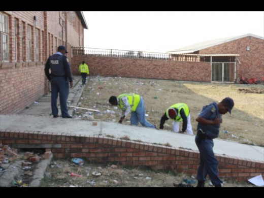 Police search the yard of Vukuqakaze Secondary School.