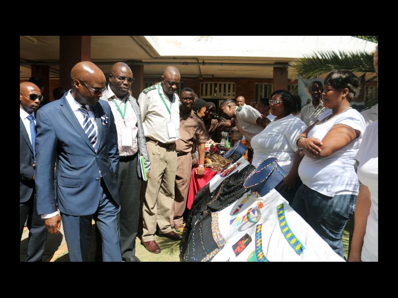 Mr Thabang Makwetla (Deputy Minister) with officials at the art gallery stall that was prepared by offenders.