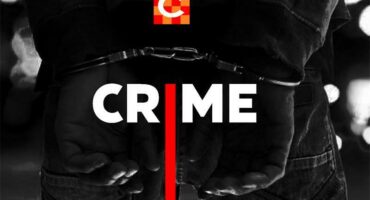 A man in a white shirt and maroon cap.