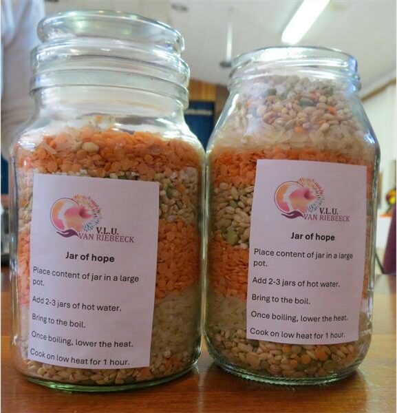 Two jars of food with labels on them.