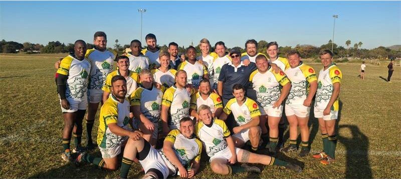 A group of rugby players posing for a photo.