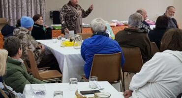 A group of people sitting at tables in a room.