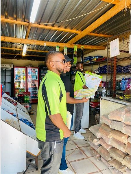 Two men in a store looking at a magazine.