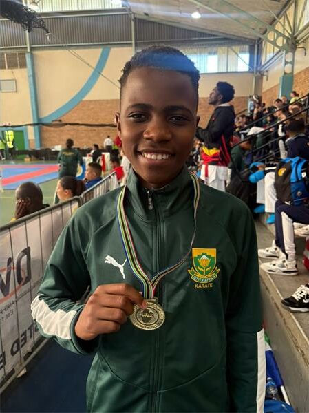A young boy with a medal on his neck.
