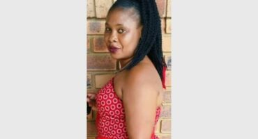 A woman with dreadlocks and a red dress.
