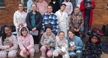 A group of children in pajamas posing for a picture.
