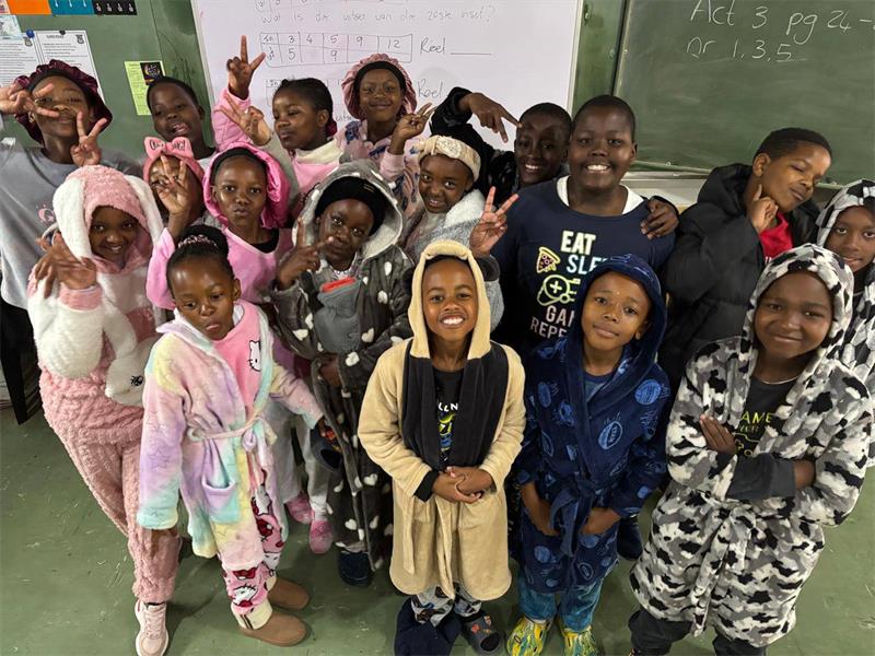 A group of children in pajamas posing for a picture.