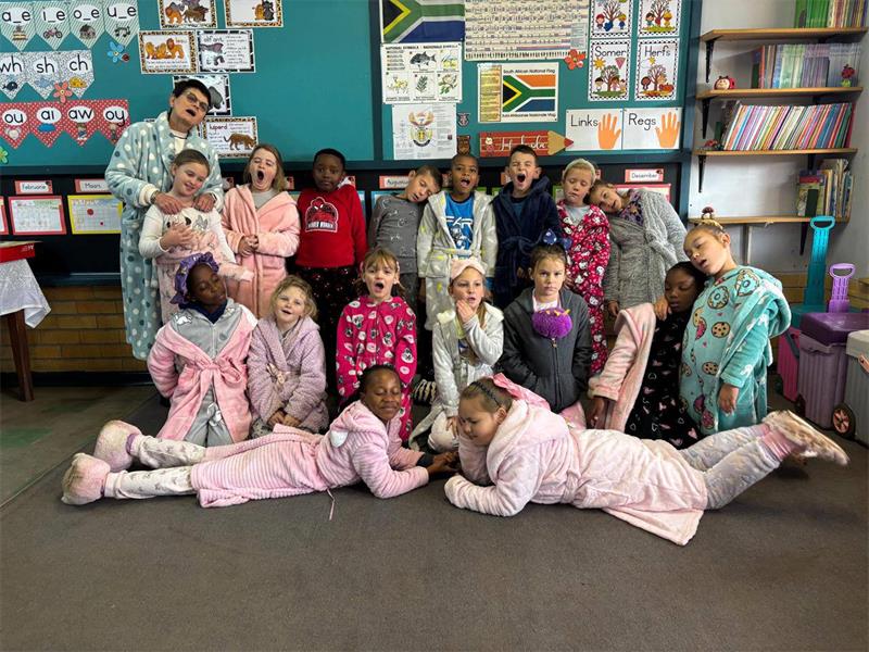 A group of children in pajamas posing for a picture.