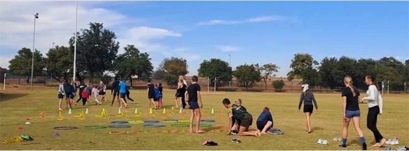 A group of people exercising on a field.
