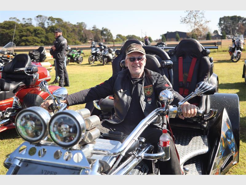 A man sitting on a motorcycle with a helmet on.