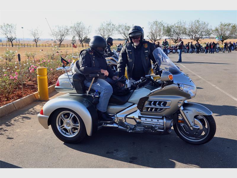 A man and a woman on a motorcycle.