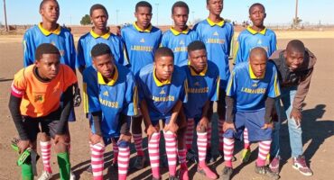 A group of young men in soccer uniforms.