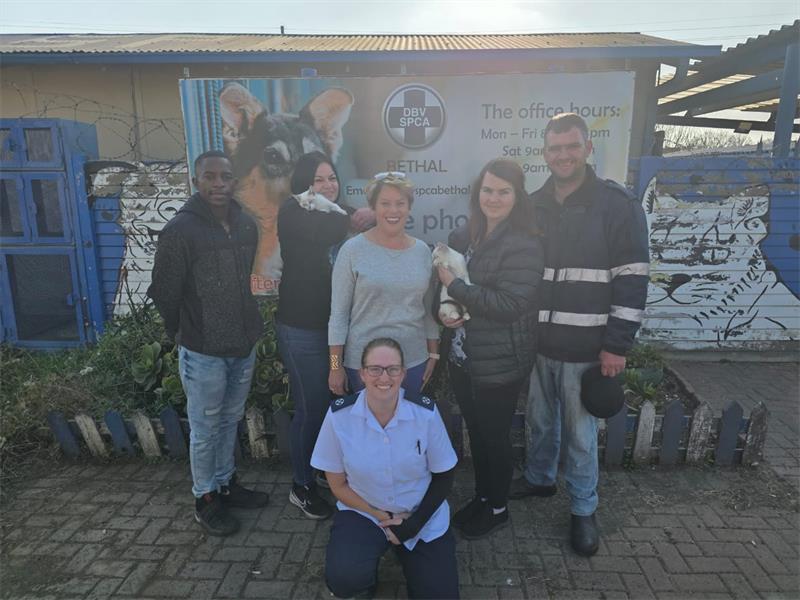 A group of people posing for a photo in front of a building.