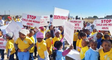 Children holding signs and holding up signs.