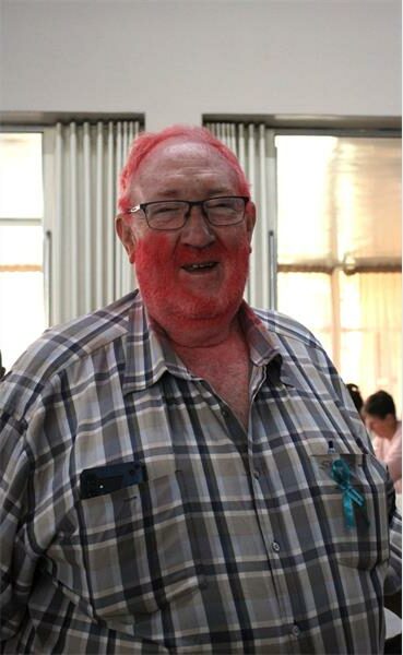 A man with red hair and beard posing for a picture.
