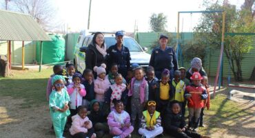 A group of children and adults posing for a photo.