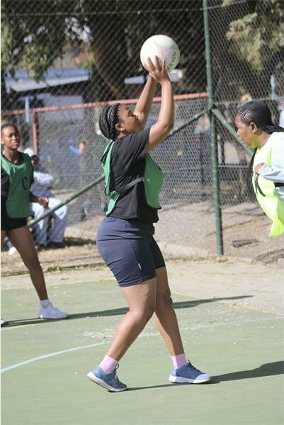 A group of girls playing a game of netball.