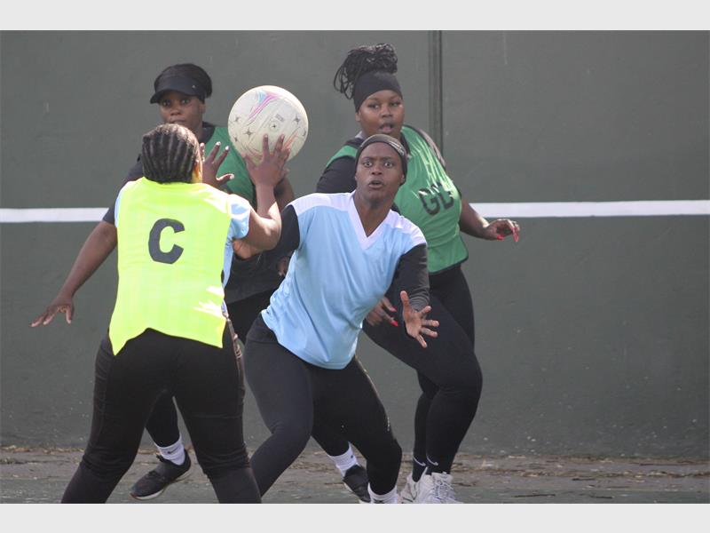 A group of women playing a game of soccer.