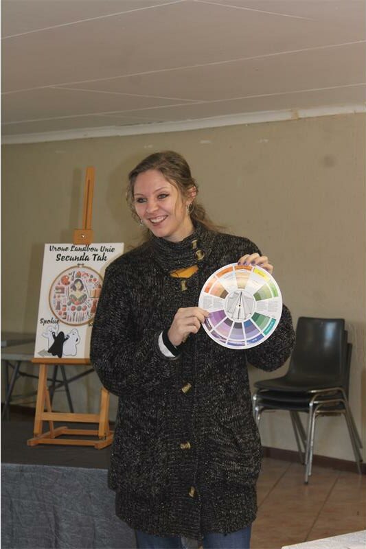 A woman holding a wheel of color.