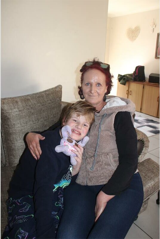 A woman and a child sitting on a couch.
