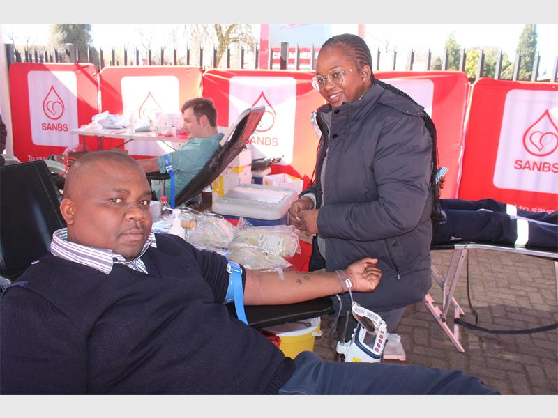 A man getting blood from a woman.
