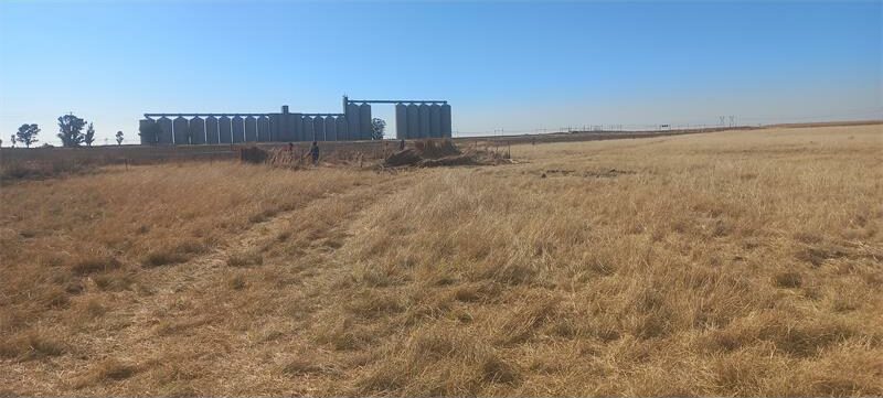 A field with a building in the background.
