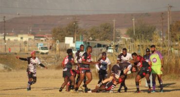 A group of people playing a game of rugby.