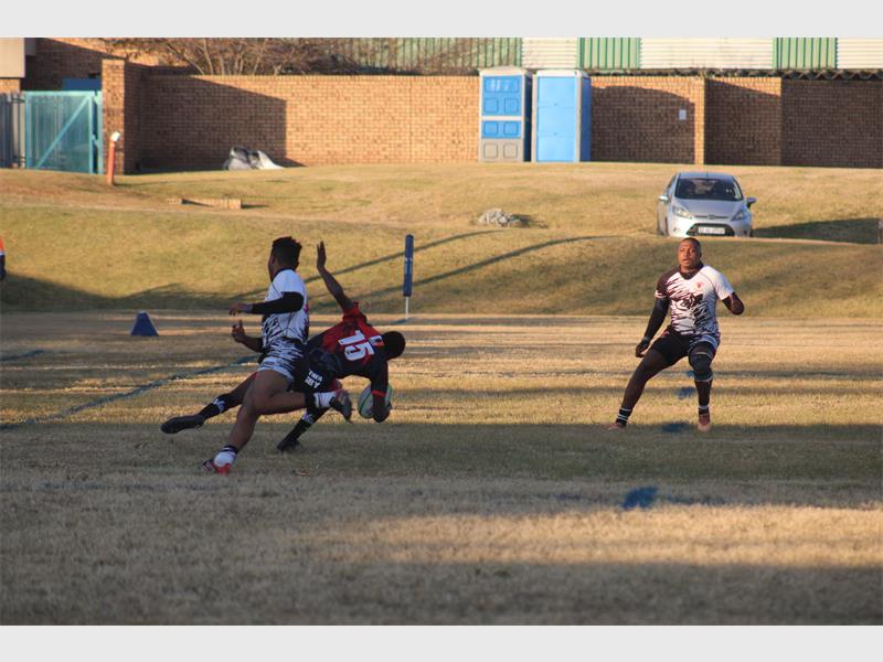A group of people playing a game of frisbee.