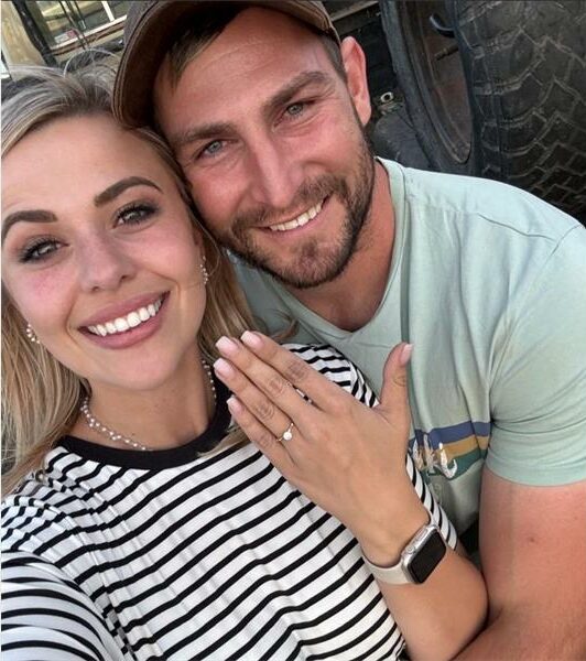 A man and woman are posing for a selfie.