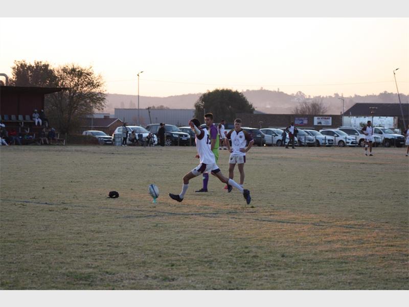 A group of people playing soccer on a field.