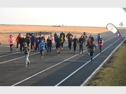 A group of people running on a track.