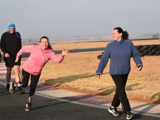 A group of people running on a road.