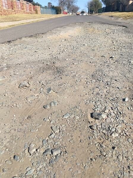 A street with gravel and dirt on it.