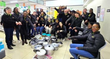 A group of people posing for a photo in a store.